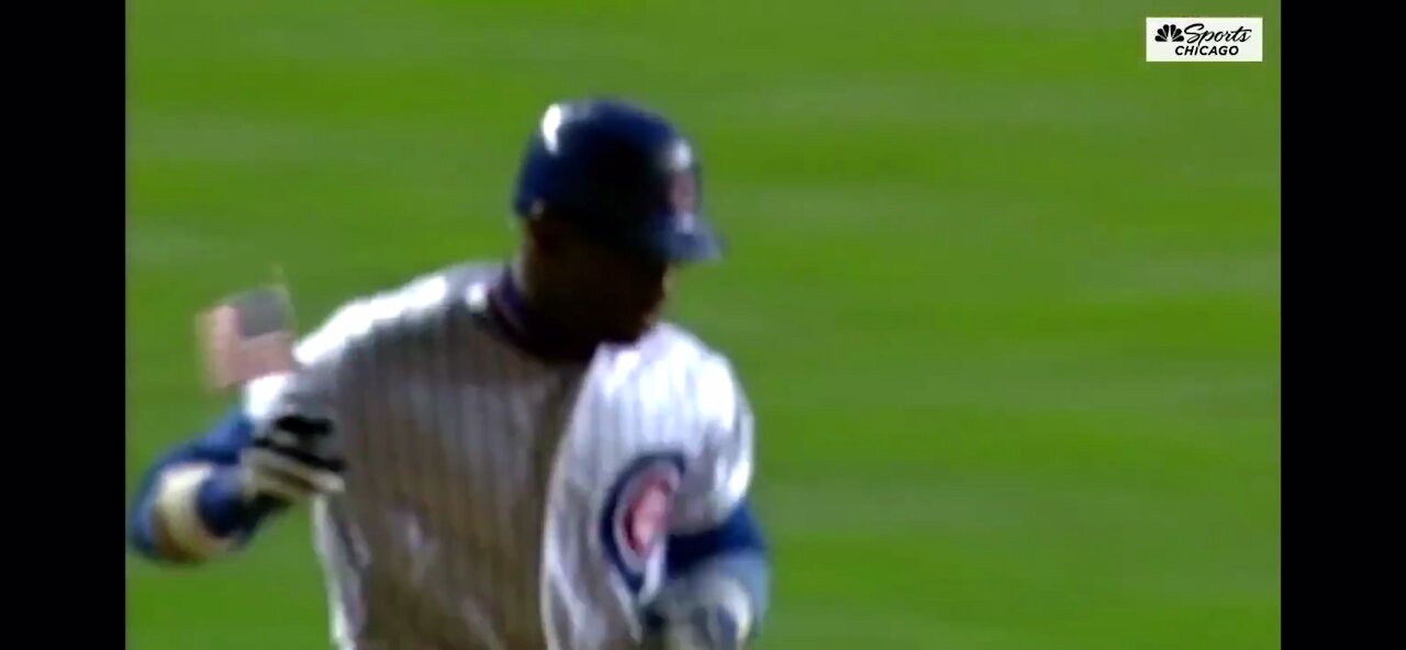 Sammy Sosa carries flag after hitting home run