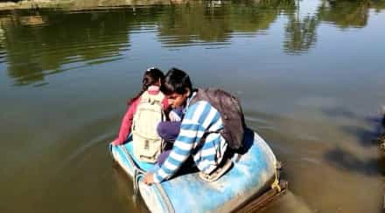 Villagers use plastic barrels to cross a river in India