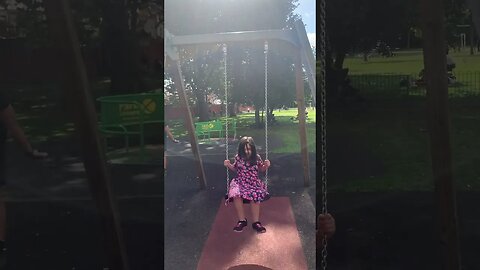 Baby girl do swing in the sun-a little rainbow of colours