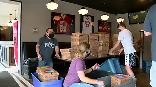 Nearly 100 volunteers deliver pizza to health clinics, hospitals and fire stations