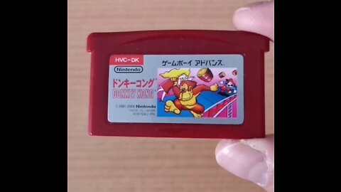 Evading barrels thrown by Donkey Kong in Donkey Kong Famicom Mini for the Game Boy Advance loaded in Nintendo Game Boy Advance SP Famicom Console
