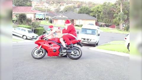 "Santa Falls Off Red Motorcycle"