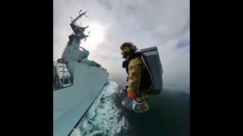 Marines perform boarding exercise with jetpacks and land on a high-speed ship