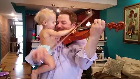 "Baby Helps Dad's Violin Practice"