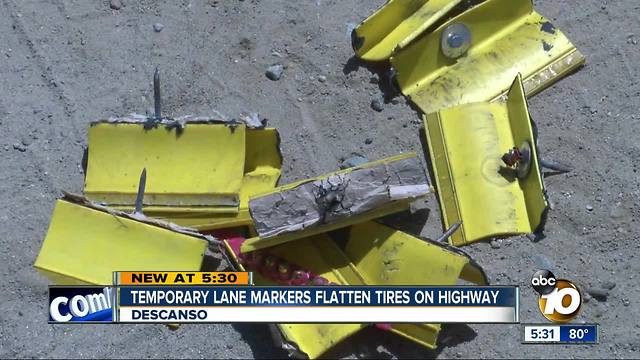 Lane markers flatten tires on highway