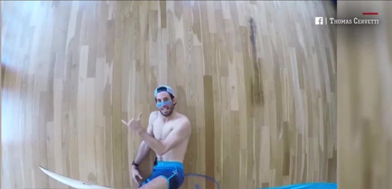 Surfer rides waves inside apartment