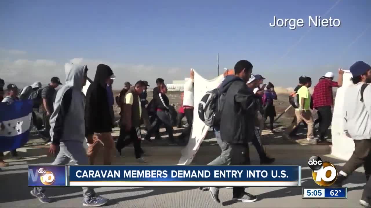 Caravan members demand entry into U.S.