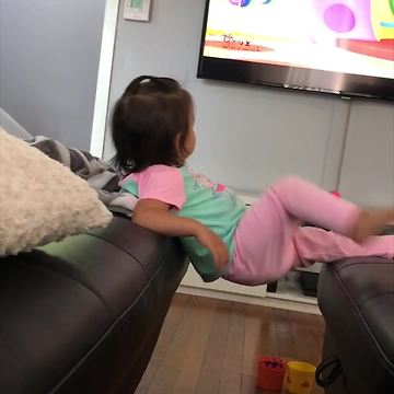 Cute Girl Falls While Watching Cartoons