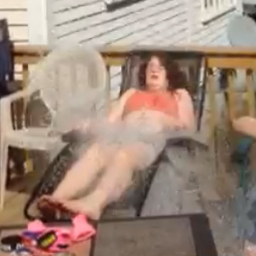 Man On Roof Dumps Bucket Of Water Onto Tanning Girls