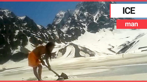 Holy man digs through ice to take an outdoor bath in the Himalayan mountains