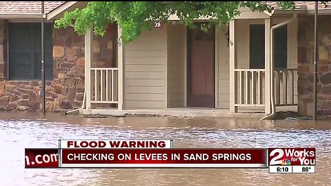 Checking on levees in Sand Springs