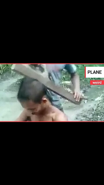 This is the bizarre moment a barber gave a man a hair trim - using a WOOD PLANE