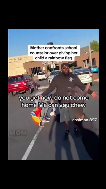 Los Angeles, California school counselor gives a child a Rainbow Pride Flag..