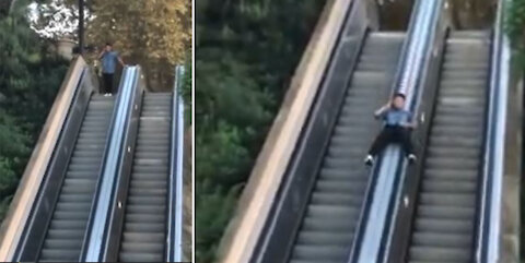 Guy Slides Down Escalator While Talking On Phone