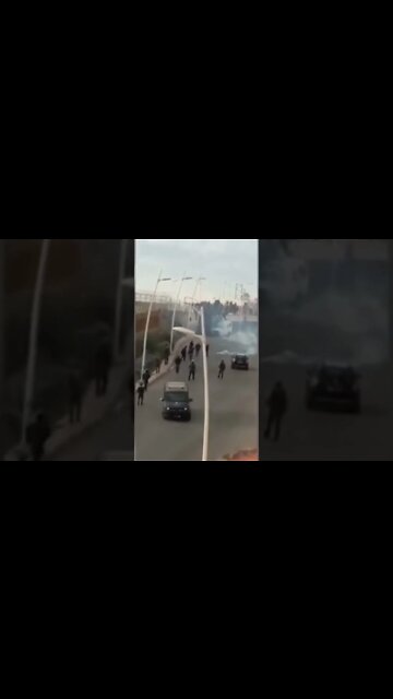 Migrants surge the crossing point by climbing walls and fell. Video filmed on the Moroccan side