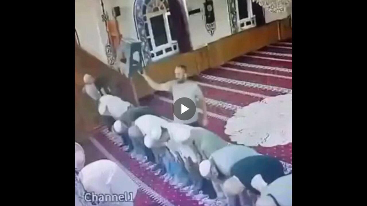 A guy hitsvthe imam on the head several times with a plastic stool...