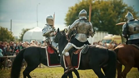 Knights having a battle on wooden swords on the field - medieval festival