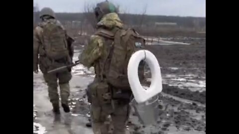 Ukrainian Soldier Carries Toilet In Bakhmut