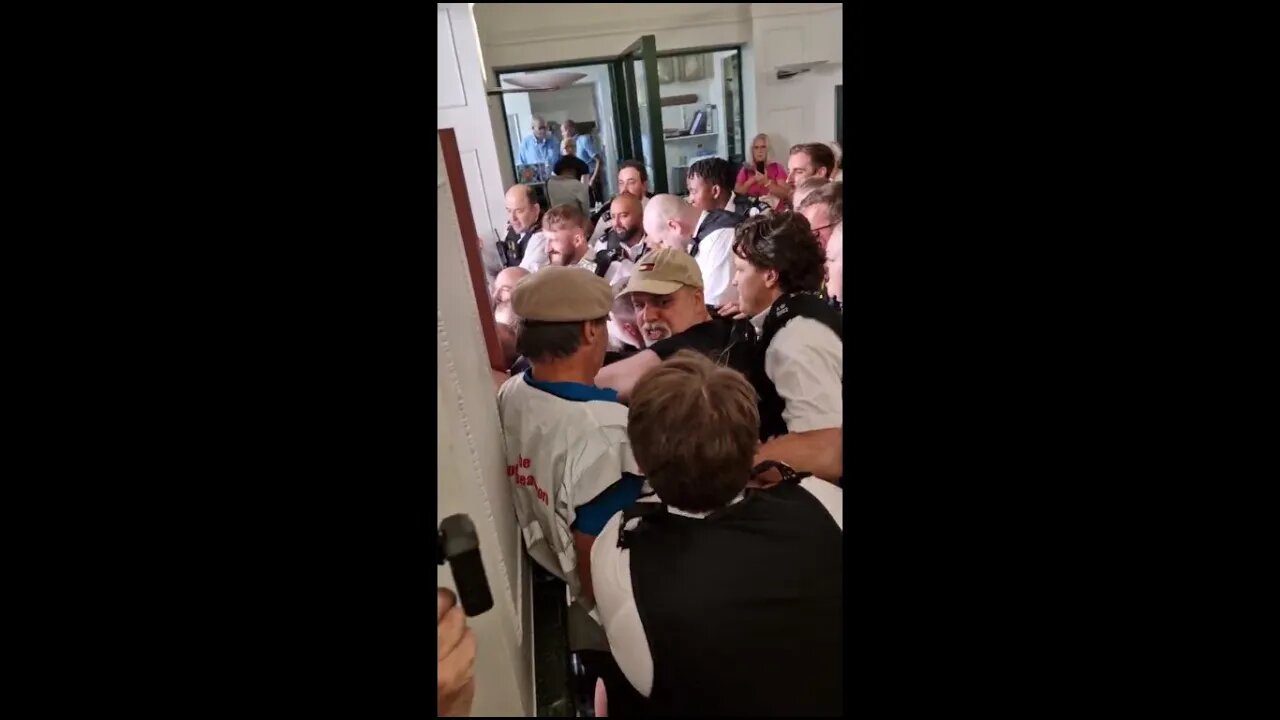 Government agents using brute force to deny citizens access to a public building.