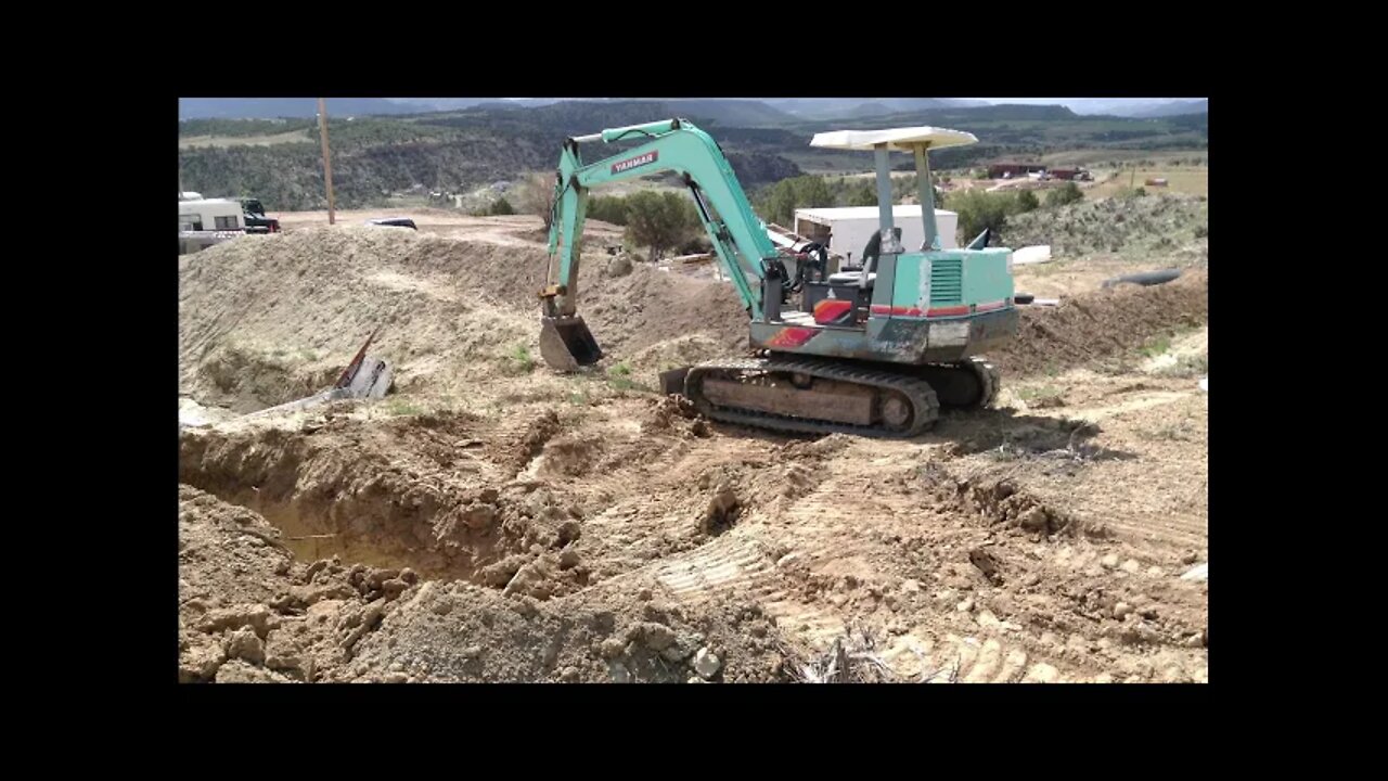 YB 451 Yanmar Excavator Digging A Trench