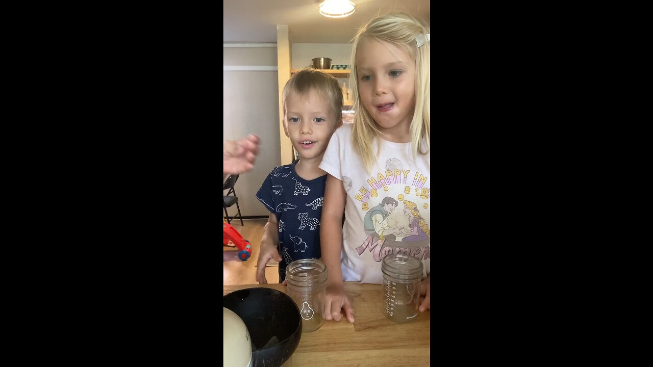 Kids making their own strawberry milk