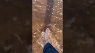 Walking through water at the beach