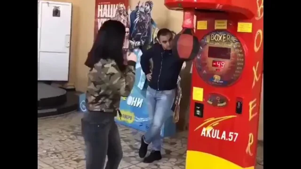 Women Punches Guy Instead Of Punching Machine