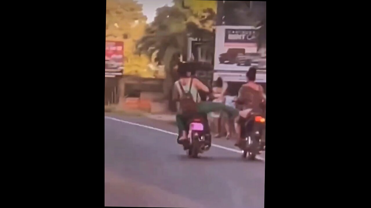 instant karma- chick on back of bike kicks chick riding beside her