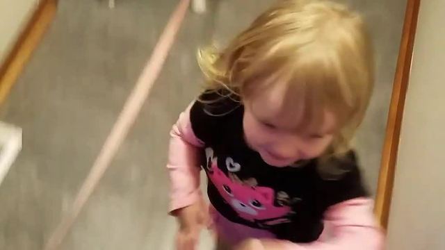 Excited toddler affectionately hugs everyone