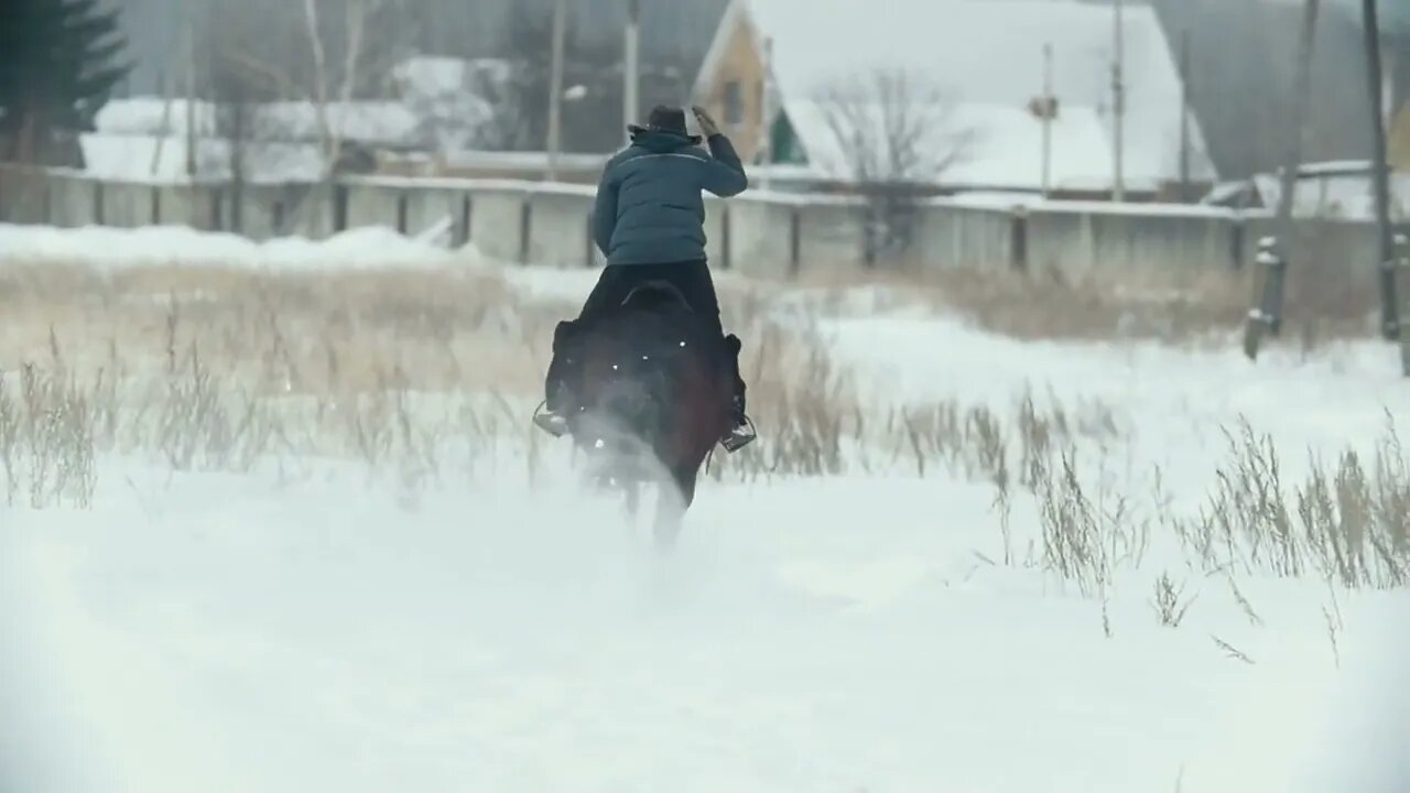 Young woman in hat galloping on snow