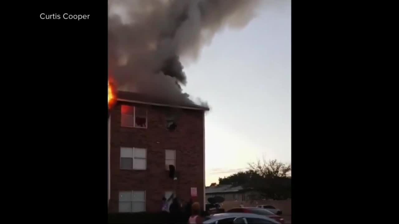 Dramatic video shows mom throwing child out of window to escape fire