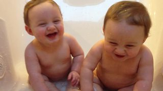 "Twin Baby Boys Giggle and Splash in A Bathtub"