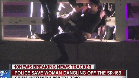 Police save woman dangling off Highway 163 overpass