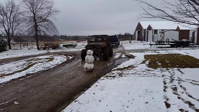 "A Man Runs Over A Snowman In A Jeep"