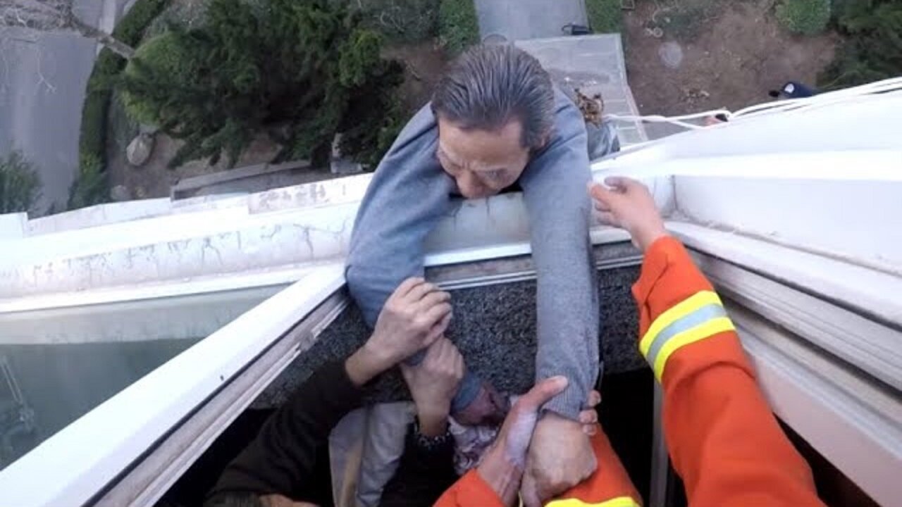 Firefighter Saves Man From Falling Out Window