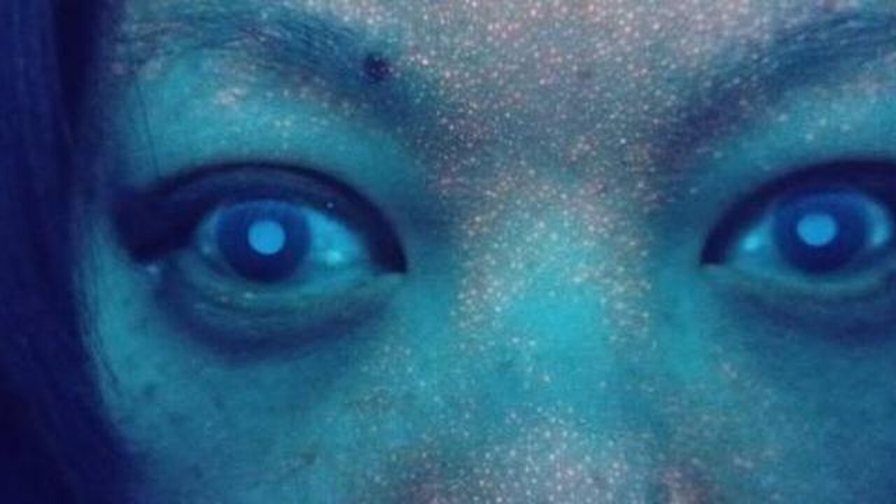 Fluorescent Orange Face Tattoo Under UV Light In C19 Vaccinated And Eye Of Horus Phenomenon