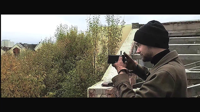 Drone shows an old-fashioned man exploring an abandoned village