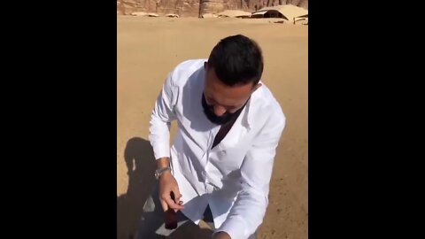 DJ Khaled getting a haircut in the middle of the desert