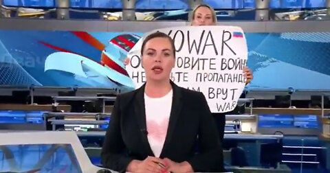 Woman Runs Into Frame, Interrupts Live Russian Broadcast to Protest War in Ukraine