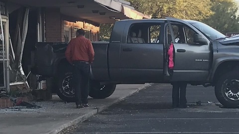 Car crashes into building in midtown