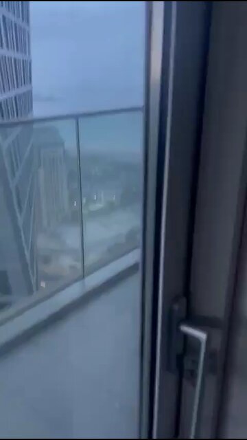 Heavy winds in Dubai slams window cleaner into building