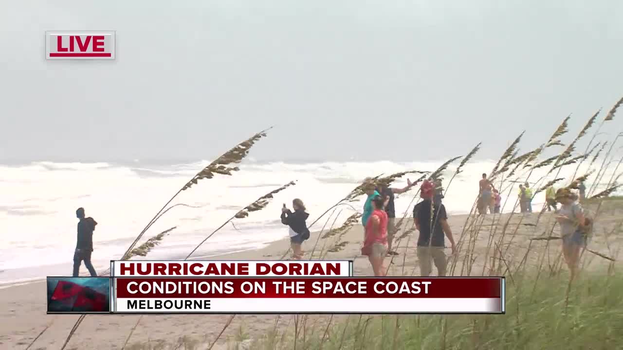 High waves from Hurricane Dorian bring people to the beach in Melbourne