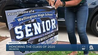 Volunteers place signs in yards of Wellington High School seniors