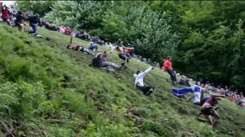 People throw themselves down a hill for... cheese!