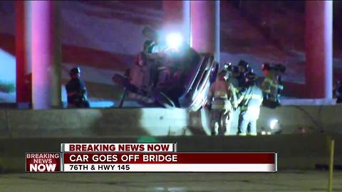 Car goes off bridge, crashing onto highway