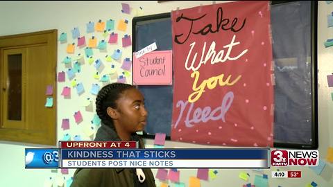 Student makes post its with kind words for others
