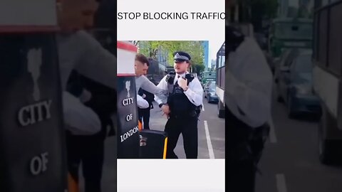 It's not illegal to block traffic but it is illegal to push someone out of the way to block traffic?