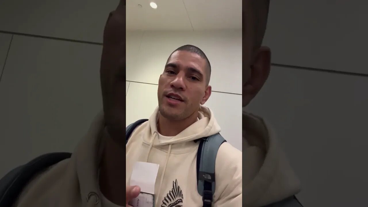 Alex Pereira and Israel Adesanya next to each other in line at an airport in Australia today