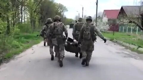 American supremacist Paul Gray is hauled by Ukrainian terrorist soldiers; his foot is wounded.