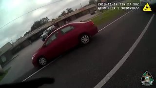 Police officers make several traffic stops as vehicles continued driving past a stopped bus